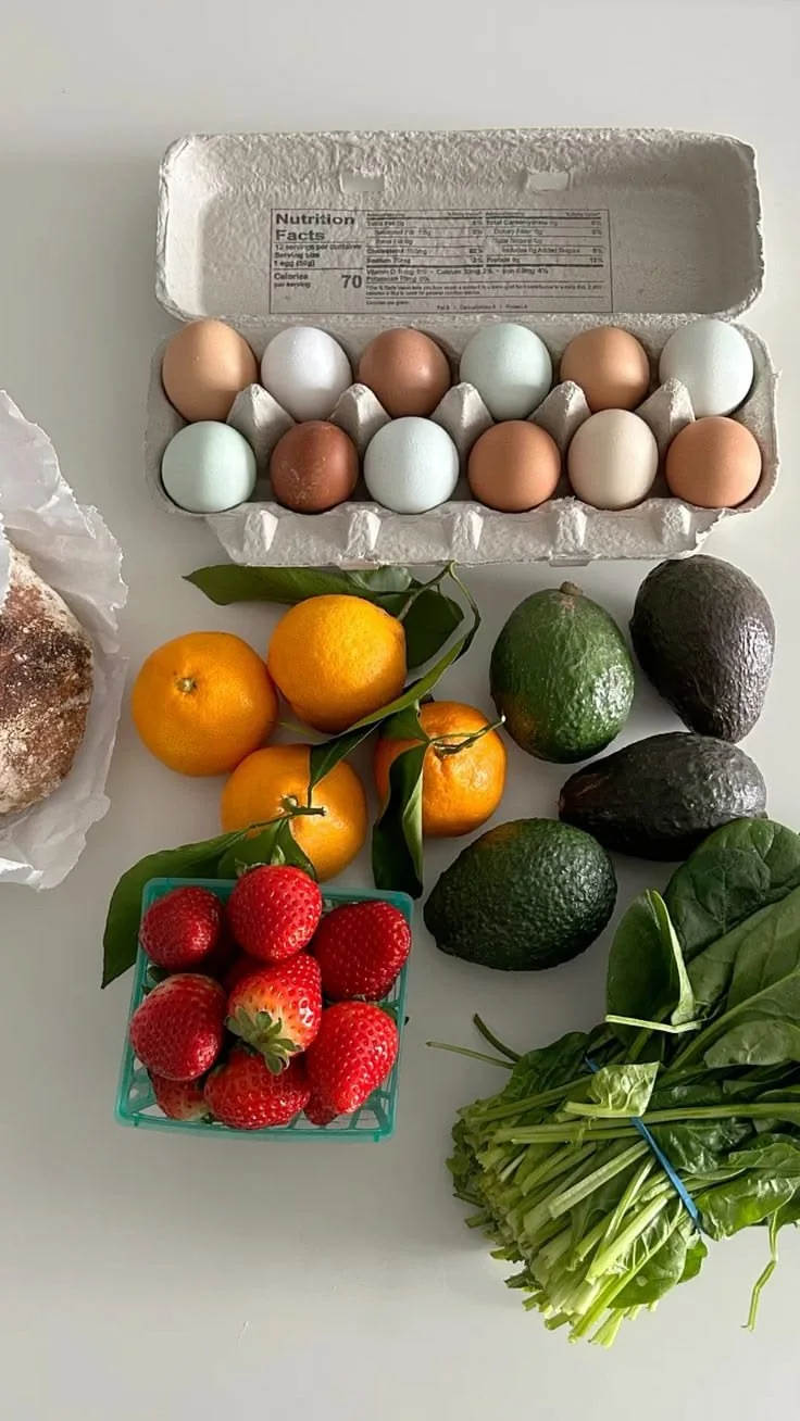 Fresh produce and eggs laid out for a week of meals